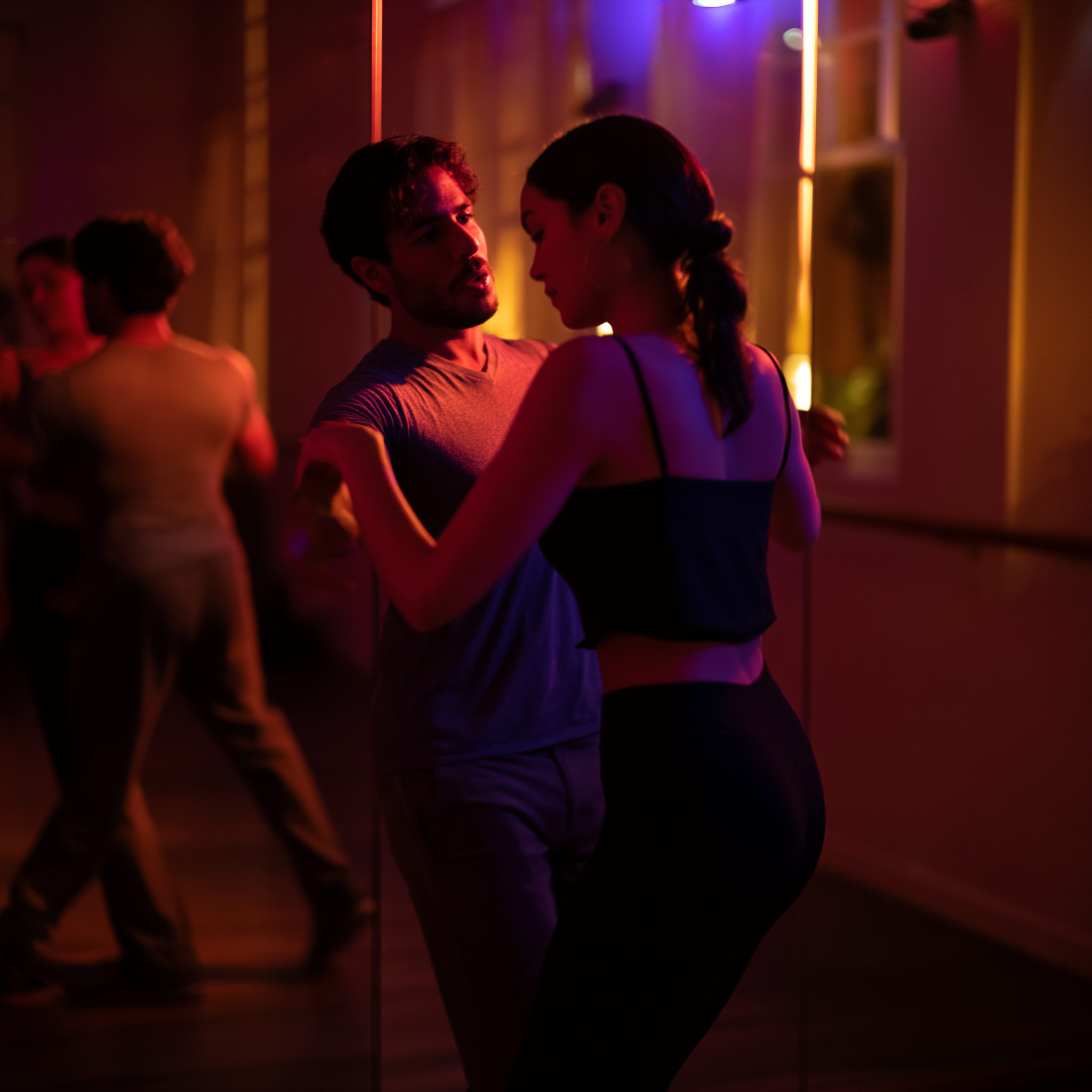 One-on-one bachata lesson in a small Latin dance studio, mirrors reflecting instructor and student